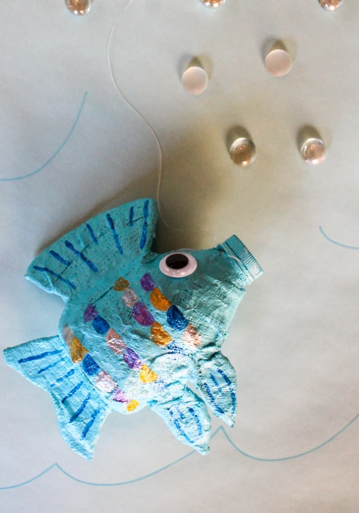 Make a fish sculpture with an empty water bottle and Rigid Wrap plaster cloth! This free lesson plan will show you how to use water bottles as armatures to create fun projects for the art room. #armature #fishsculpture #lessonplan